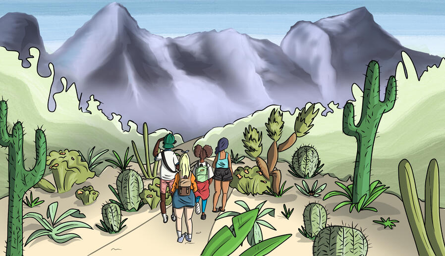 Four people approach the base of a desert mountain